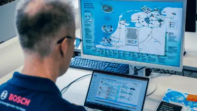 Arjen Brandsma at his computer with a report open, working on the initial innovation steps for developing a Bosch electrolyzer.