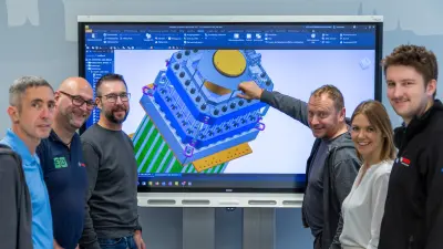 Six people in a construction meeting for in-house developed electrolyzes tensioning tool 