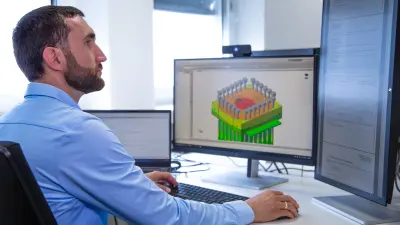 Bosch engineer working on computer with CAD model of electrolysis stack