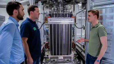 Markus, Bernhard and their colleague Philipp in front of a test bench